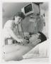 Primary view of [Woman Standing Over Patient]