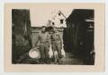 Photograph: [Two Soldiers Preparing Chickens]