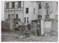 Photograph: [Soldiers near a Cement Building]