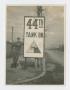 Photograph: [Soldier Leaning on Sign]