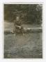 Photograph: [Soldier Sitting on a Log]