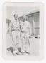 Photograph: [Sergeant Onsrud and Another Soldier Standing by a Hutment]