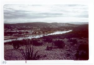 Primary view of object titled '[Body of water at Big Bend National Park surrounded by buildings and hills]'.