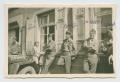 Photograph: [Five Soldiers Leaning Against a Building with Two Girls]