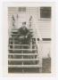 Photograph: [Soldier Sitting at the Top of Barracks Steps]