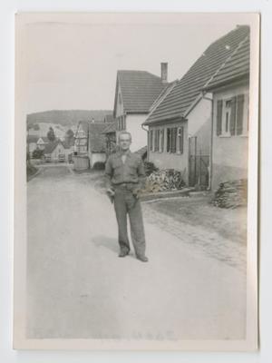 Primary view of object titled '[John Wiech Standing in a Village Street]'.