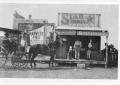 Photograph: [Buggy with horse in front of store]