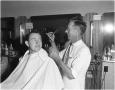 Photograph: S.J. Middleton receiving a haircut