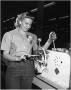 Photograph: Ida Stephensen operating a Tube-bending Machine