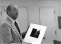 Photograph: [Photograph of Dr. Fletcher with Picture]