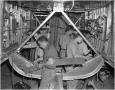 Photograph: Ten men working inside an airplane fuselage