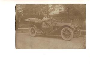 Primary view of object titled '[Man in Pierce-Arrow automobile]'.