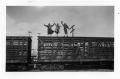 Photograph: Women  on top of a Cattle Car