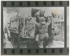 Primary view of object titled '[Medics Mounting a Half-Track]'.