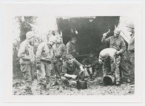 Primary view of object titled '[Nine Soldiers by a Lean-To in France]'.