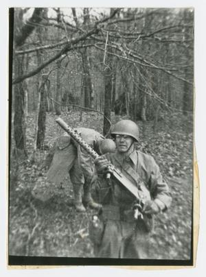 Primary view of object titled '[Soldier Carrying a .30 Caliber Machine Gun]'.