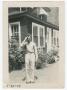 Photograph: [William Giannopoulos Saluting in Front of a House]