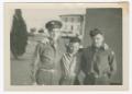 Photograph: [Three Uniformed Men Standing by a Wall]