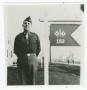Photograph: [Captain Louie McGraw by a 152nd Signal Company Sign]