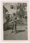 Photograph: [Soldier Holding a Large Projectile]