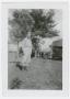 Photograph: [Verne Mauer Standing by a Tree]