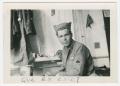 Photograph: [American Soldier Sitting in a Room]