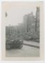 Photograph: [Tank Beside Bombed Buildings]