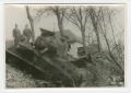 Photograph: [Two Soldiers Posing by Wrecked Sherman Tank]