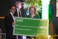 Photograph: [Angela Wilson with check at Salute to Faculty Excellence event]