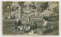 Photograph: [Photograph of People Sitting by a Rock Slope]