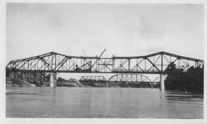 Primary view of object titled '[The final construction phase of the Brazos River Bridge.]'.