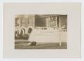 Photograph: [Vehicle in Front of Building]