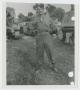 Photograph: [Soldier In Front of Tanks]