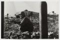 Photograph: [Soldier with Rifle Kneeling by Barbed Wire]