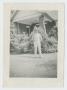 Photograph: [Soldier In Front of Building]
