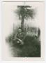Photograph: [Jim Lineback Crouching Underneath a Tree]