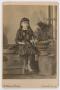 Photograph: [Photograph of Unidentified Girl on Stone Wall]
