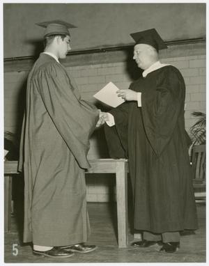 Primary view of object titled '[Concordia Graduate Shaking Hands with a Faculty Member]'.