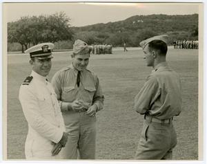 Primary view of Three Men in Uniform Talking and Laughing