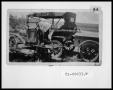 Photograph: B. F. Cox Sr. Working on Car and Trailer