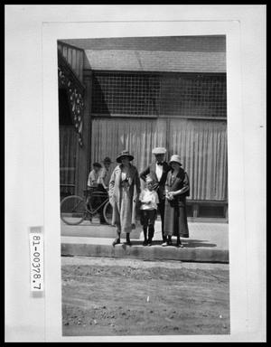 Primary view of object titled 'Man, Two Women, and Child on Sidewalk'.