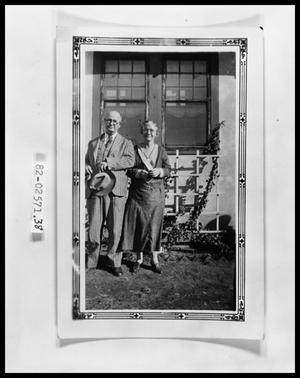 Primary view of object titled 'Snapshot of Two Adults by House'.