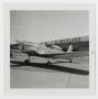 Primary view of [Airplane in Front of Hangar]