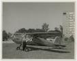 Photograph: [Woman Standing with Airplane]