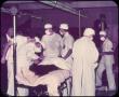 Photograph: [Photograph of Men Standing in Operating Room]