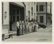 Photograph: [Firemen Standing at Attention Outside Station]