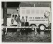 Photograph: [Men Standing by Civil Defense Truck]