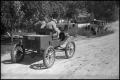 Primary view of [Photograph of Men Driving Old Car]