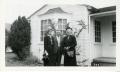 Photograph: [Photograph of Group in Front of House]