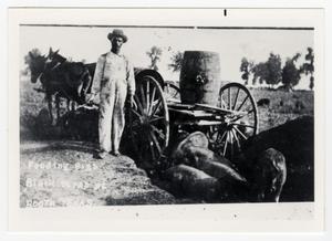 Primary view of object titled '[African American Man Feeding Pigs]'.